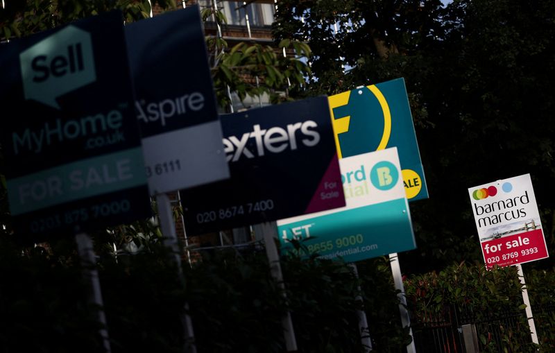 © Reuters. FILE PHOTO: Property estate agent sales and letting signs are seen attached to railings outside an apartment building in south London, Britain, September 23, 2021. REUTERS/Hannah McKay/File Photo