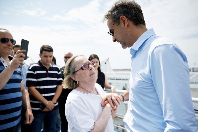 &copy; Reuters. Former Greek Prime Minister and New Democracy conservative party leader Kyriakos Mitsotakis speaks with a person on a ferry by the island of Salamina, Greece, June 13, 2023. REUTERS/Louiza Vradi