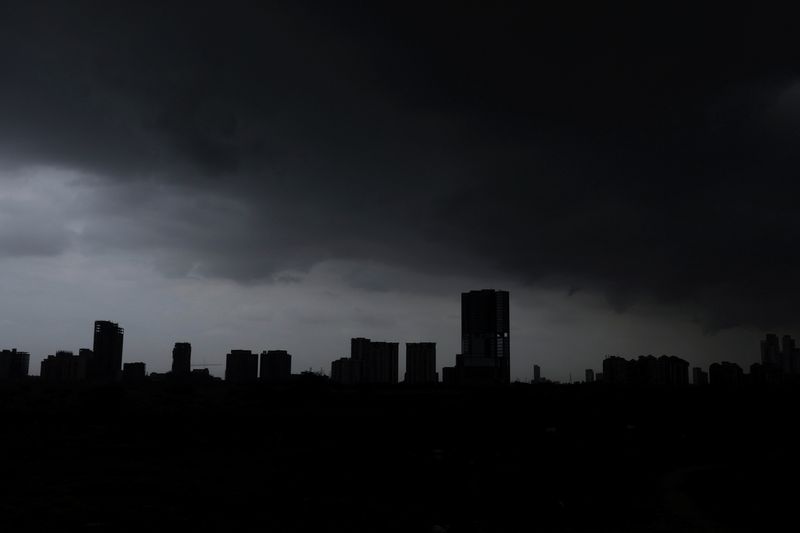 © Reuters. A view of residential buildings partially covered with rain clouds, before the arrival of cyclonic storm, Biparjoy, over the Arabian Sea, in Karachi, Pakistan June 15, 2023. REUTERS/Akhtar Soomro