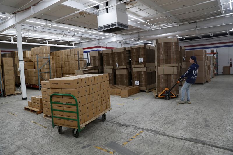 &copy; Reuters. An employee of Defender Safety moves products inside their warehouse in Plainview, New York, U.S., March 24, 2021. REUTERS/Shannon Stapleton