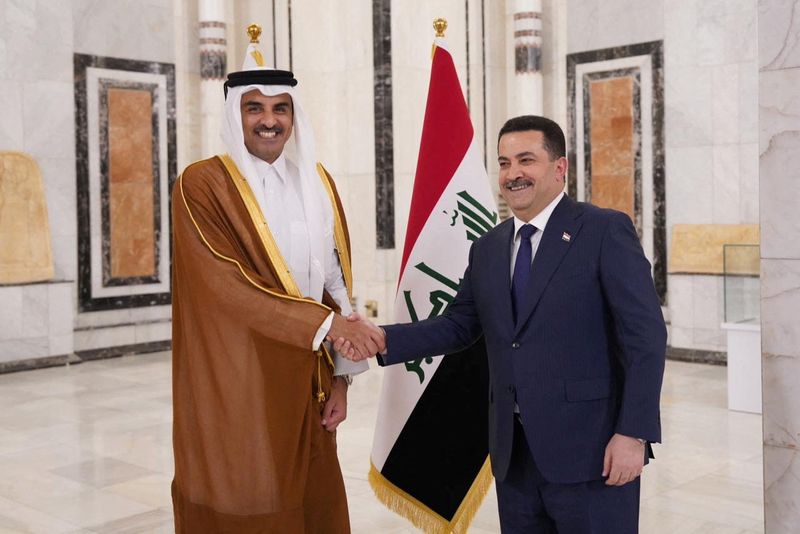 &copy; Reuters. Iraqi Prime Minister Mohammed Shia al-Sudani shakes hands with Qatar's Emir Sheikh Tamim bin Hamad al-Thani during a welcome ceremony, in Baghdad, Iraq June 15, 2023. Iraqi Prime Minister Media Office/Handout via REUTERS  