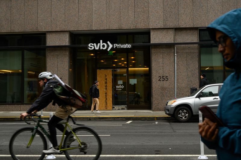 &copy; Reuters. FILE PHOTO: Pedestrians and a cyclist pass by the Silicon Valley Bank branch office in downtown San Francisco, California, U.S., March 13, 2023. REUTERS/Kori Suzuki/File Photo