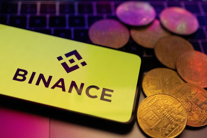 &copy; Reuters. FILE PHOTO: A smartphone with displayed Binance logo and representation of cryptocurrencies are placed on a keyboard in this illustration taken, June 8, 2023. REUTERS/Dado Ruvic/Illustration/File Photo