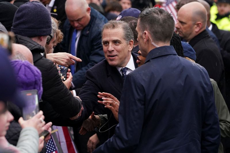 © Reuters. FILE PHOTO: Hunter Biden greets people on a street as U.S. President Joe Biden visits Dundalk, Ireland, April 12, 2023. REUTERS/Kevin Lamarque/File Photo