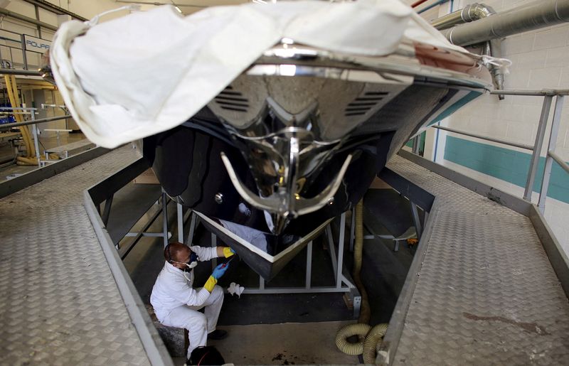 &copy; Reuters. FILE PHOTO: An employee works on a yacht at the Ferretti's shipyard in Sarnico, northern Italy, April 7, 2015. REUTERS/Stefano Rellandini/File Photo