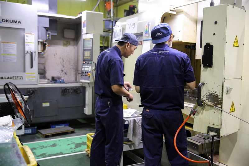 &copy; Reuters. FILE PHOTO: Workers check the machinery at the factory of aircraft component manufacturer Aoki in Higashiosaka, Japan June 22, 2022. REUTERS/Sakura Murakami/File Photo