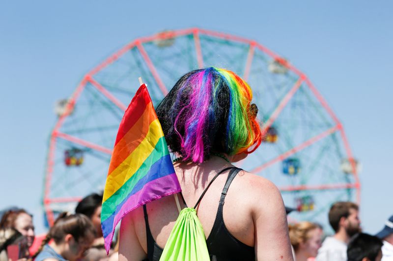 © Reuters. FILE PHOTO: A participant wears a LGBT flag as people take part in the Annual Mermaid Parade in Brooklyn, New York, June 18, 2016. REUTERS/Eduardo Munoz/File Photo