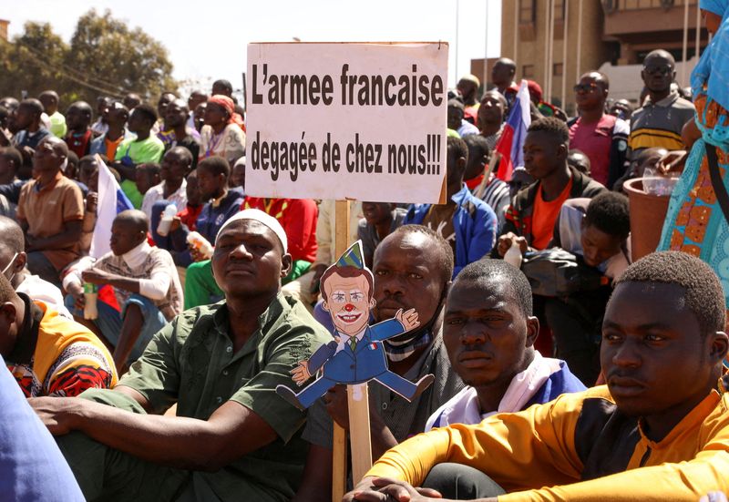 &copy; Reuters. FILE PHOTO: People hold a sign as they gather to show their support to Burkina Faso's new military leader Ibrahim Traore and demand the departure of the French ambassador at the Place de la Nation in Ouagadougou, Burkina Faso January 20, 2023.  REUTERS/Vi