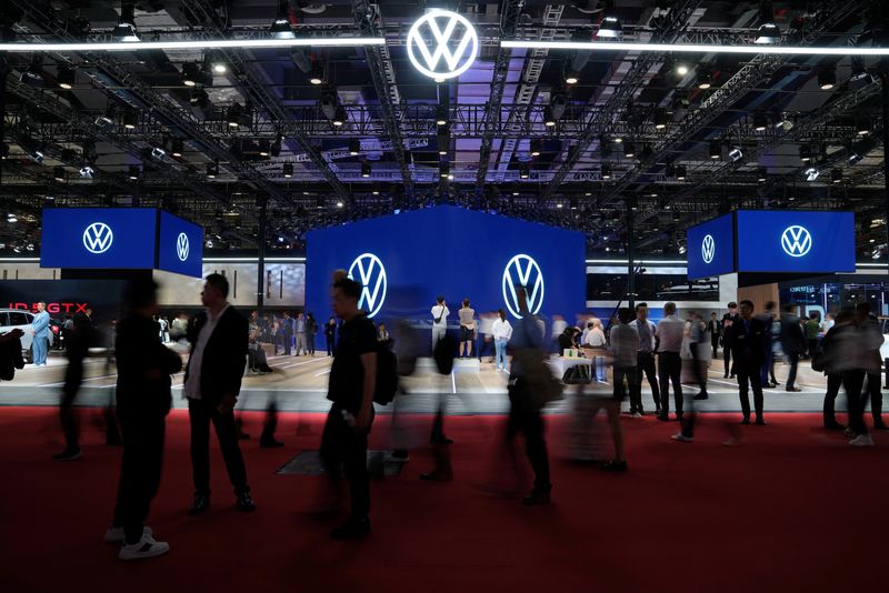 &copy; Reuters. Visitors walk past the Volkswagen booth at the Auto Shanghai show, in Shanghai, China April 18, 2023. REUTERS/Aly Song