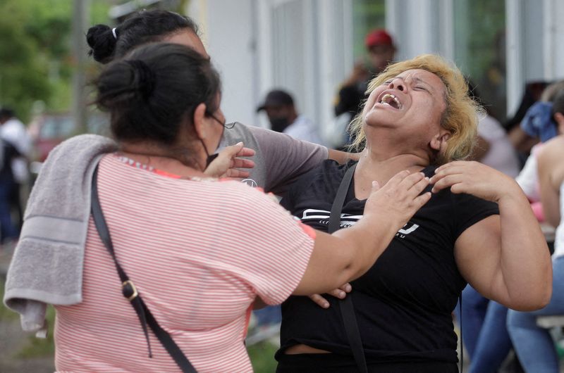 &copy; Reuters. The relative of an inmate reacts while others try to comfort her as they wait for news about their loved ones outside the Centro Femenino de Adaptacion Social (CEFAS) women's prison following deadly riot in Tamara, on the outskirts of Tegucigalpa, Hondura