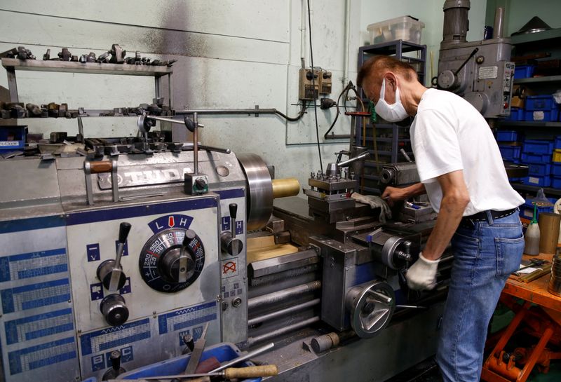 &copy; Reuters. FILE PHOTO-A man handles a machine at lampshade manufacturer Seiko SCM in Higashiosaka, Japan June 24, 2022.  REUTERS/Sakura Murakami