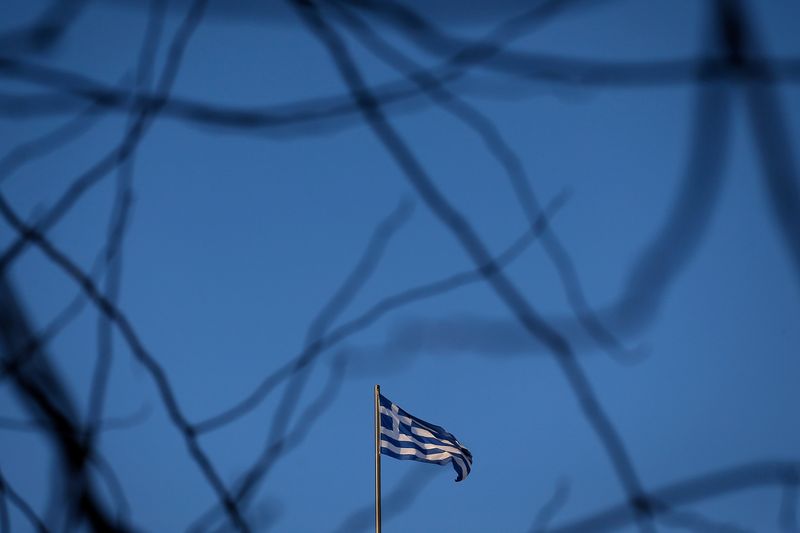 &copy; Reuters. FILE PHOTO: A Greek national flag flutters on the roof of a building in Athens, Greece February 8, 2018. REUTERS/Costas Baltas/ File photo