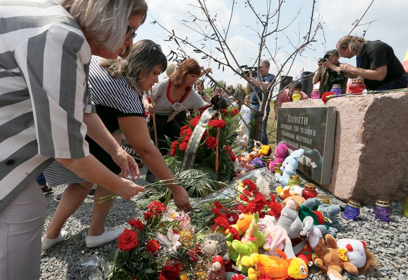 &copy; Reuters. People place flowers and toys at a memorial to victims of the Malaysia Airlines Flight MH17 plane crash during a ceremony marking the fifth anniversary of the accident near the village of Hrabove in Donetsk Region, Ukraine July 17, 2019. REUTERS/Alexander