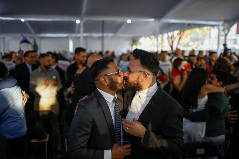 &copy; Reuters. A couple kisses during a mass wedding as part of the LGBT+ pride month celebrations in Mexico City, Mexico June 23, 2023. REUTERS/Raquel Cunha