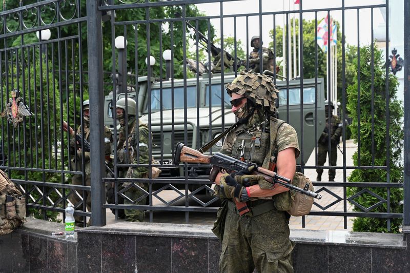 &copy; Reuters. مرتزقة مجموعة فاجنر العسكرية الخاصة يحرسون مقر القيادة العسكرية بجنوب مدينة روستوف الروسية يوم السبت . تصوير : رويترز . 