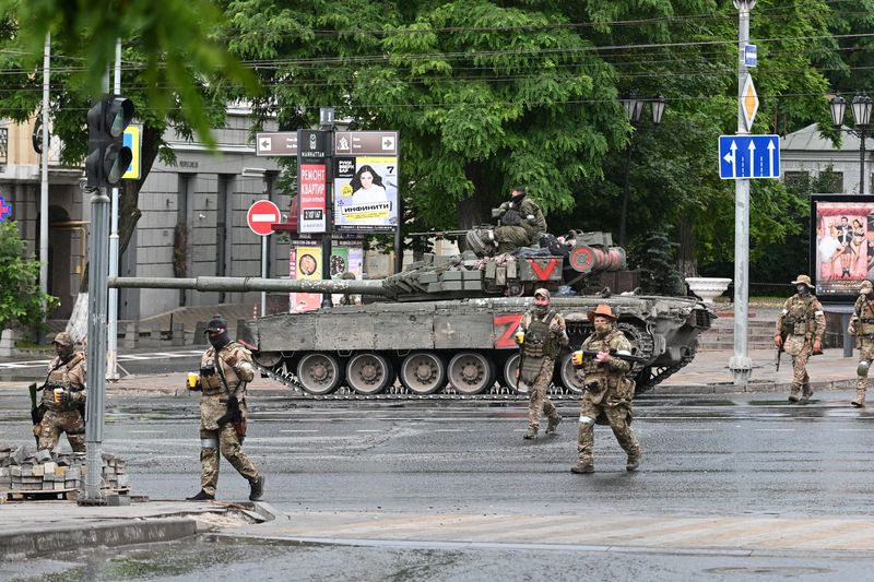 &copy; Reuters. مقاتلو مجموعة فاجنر الخاصة يقفون في حراسة خارج مقر المنطقة العسكرية الجنوبية في مدينة روستوف بروسيا يوم السبت. صورة لرويترز.