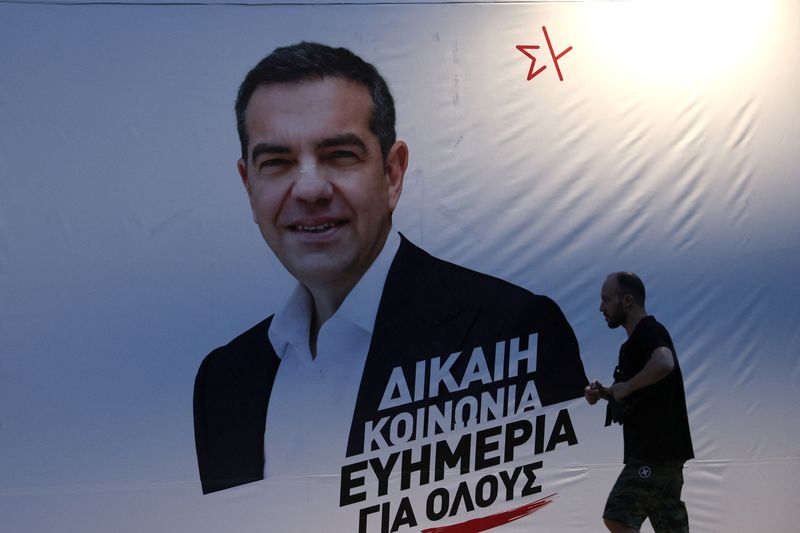 &copy; Reuters. A man walks past election banner of Leftist Syriza party leader Alexis Tsipras ahead of the general election on Sunday, in Athens, Greece, June 24, 2023.  REUTERS/Stoyan Nenov