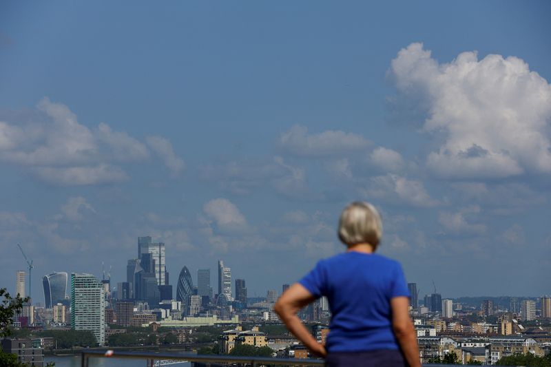 &copy; Reuters. A person looks at the City of London financial district over from Greenwich Park, in London, Britain June 22, 2023. REUTERS/Hannah McKay