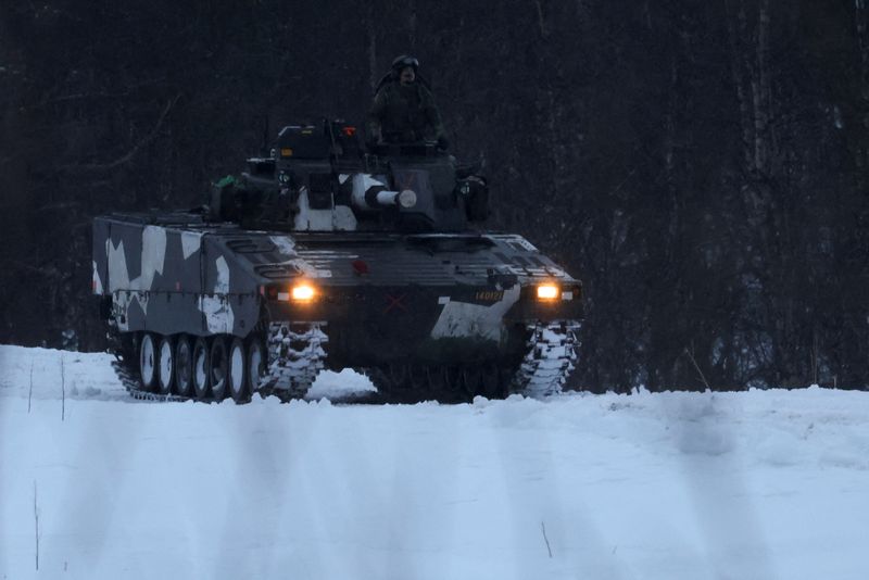 &copy; Reuters. FILE PHOTO: Swedish army members drive a an infantry fighting vehicle as part of military exercise called "Cold Response 2022", gathering around 30,000 troops from NATO member countries plus Finland and Sweden, amid Russia's invasion of Ukraine, in Seterm