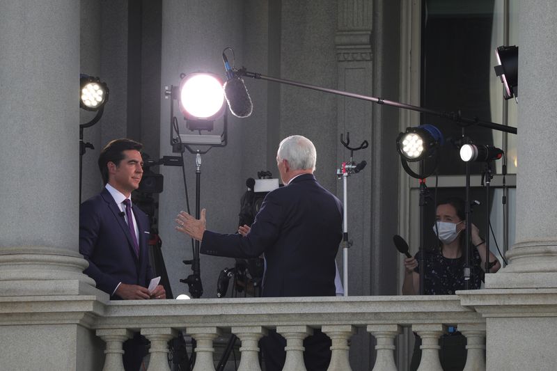 © Reuters. FILE PHOTO: Fox News commentator Jesse Watters speaks to U.S. Vice President Mike Pence during a television interview in the Eisenhower Executive Office Building at the White House in Washington, U.S., June 4, 2020. REUTERS/Tom Brenner/File Photo