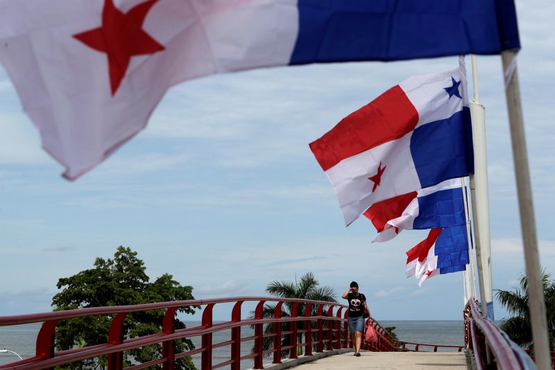 &copy; Reuters. FILE PHOTO: A woman walk pass next to Panama flags a day before the inauguration of the Panama Canal Expansion project, in Panama City, Panama June 25, 2016. REUTERS/Carlos Jasso/File Photo