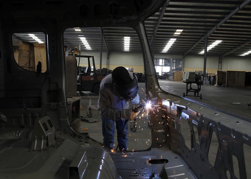 &copy; Reuters. FILE PHOTO: A worker welds a truck at an assembly of Truong Hai Dongfeng truck factory in Vietnam's northern Hung Yen province, 40 km (25 miles) east of Hanoi May 15, 2012. REUTERS/Kham 