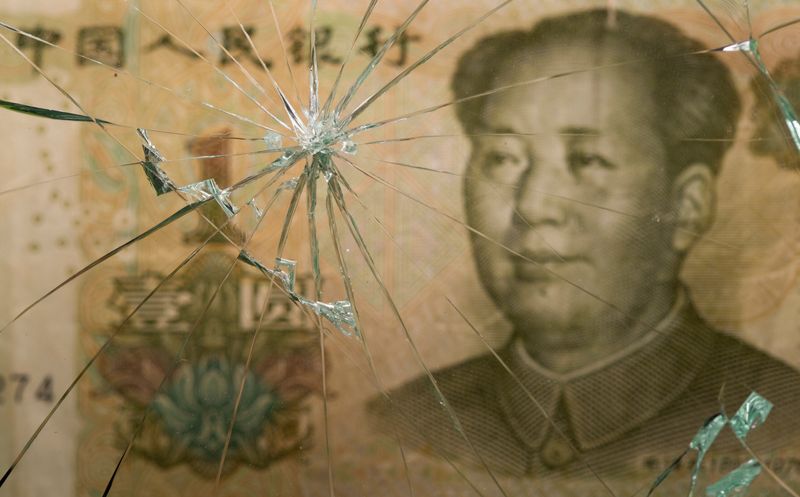 &copy; Reuters. Chinese yuan banknote is pictured through broken glass in this illustration taken June 25, 2021. REUTERS/Dado Ruvic/Illustration