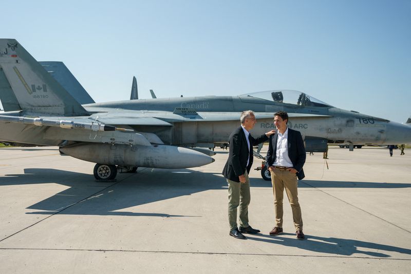 &copy; Reuters. FILE PHOTO: Canada's Prime Minister Justin Trudeau speaks with NATO Secretary General Jens Stoltenberg near a Canadian Forces CF-18 Hornet fighter aircraft during their visit to CFB Cold Lake in Cold Lake, Alberta, Canada August 26, 2022.  Adam Scotti/Pri