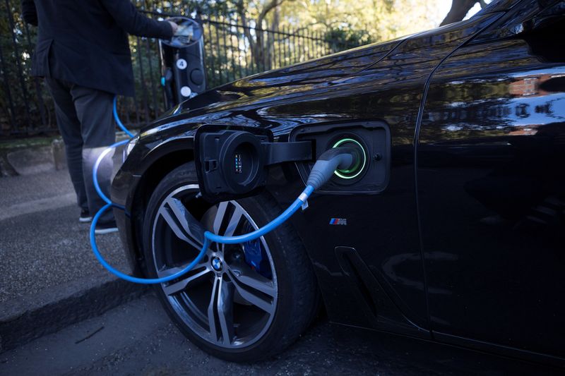 © Reuters. FILE PHOTO: A driver plugs a cable into a Source power point to charge his electric car in London, Britain, October 19, 2018. REUTERS/Simon Dawson