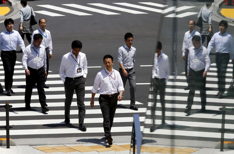 &copy; Reuters. Office workers are reflected in a glass railing as they cross a street during lunch hour in Tokyo June 1, 2015.  REUTERS/Thomas Peter/File Photo                   