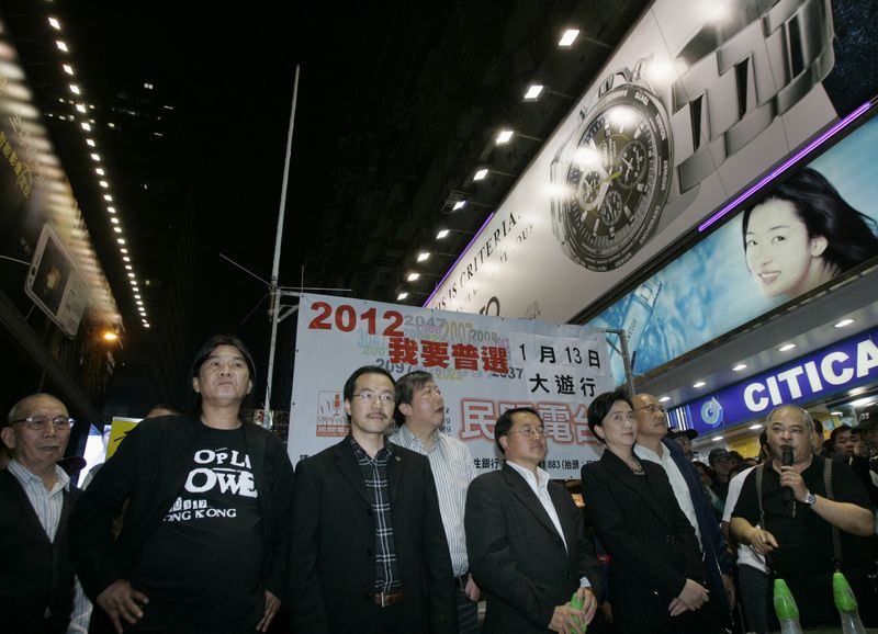 &copy; Reuters. FILE PHOTO: An antenna is set up on a street in Hong Kong's Mongkok shopping district as pro-democracy activists Leung Kwok-hung (2nd L) and Tsang Kin-shing (R), a host at Citizens' Radio, along with pro-democracy lawmakers Emily Lau (3rd R) and Lee Wing-