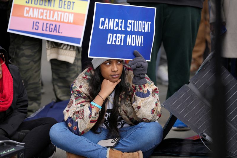 &copy; Reuters. A supporter of student loan debt relief rallies in front of the Supreme Court as the justices are scheduled to hear oral arguments in two cases involving President Joe Biden's bid to reinstate his plan to cancel billions of dollars in student debt in Wash