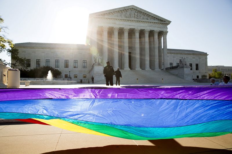 &copy; Reuters. FILE PHOTO: Gay marriage supporters hold a gay rights flag in front of the Supreme Court before a hearing about gay marriage in Washington April 28, 2015.  REUTERS/Joshua Roberts/File Photo