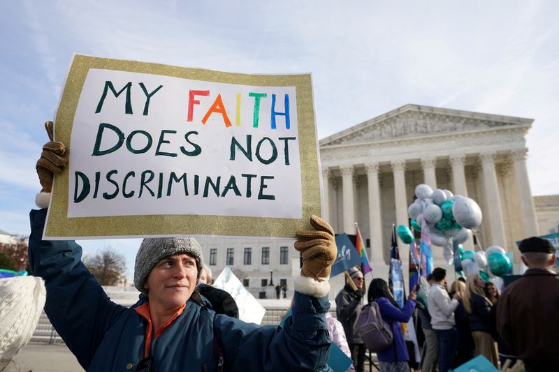 &copy; Reuters. FILE PHOTO: A protester displays a sign as activists demonstrate outside the U.S. Supreme Court, as justices were set to hear arguments in a major case pitting LGBT rights against a claim that the constitutional right to free speech exempts artists from a