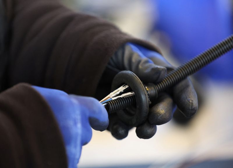 &copy; Reuters. FILE PHOTO: A worker assembles an electrical component at the Aurrigo factory in Coventry, Britain, January 18, 2023. REUTERS/Phil Noble