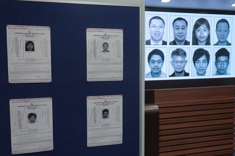© Reuters. Photos of eight activists who have been issued arrest warrants over national security are displayed during a press conference in Hong Kong, China July 3, 2023. REUTERS/Joyce Zhou
