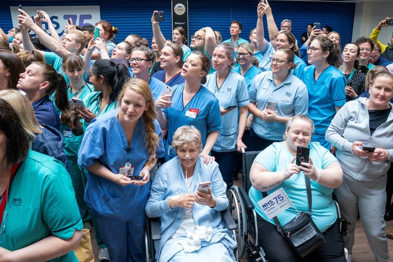 &copy; Reuters. Staff and patients wait to meet King Charles III and Queen Camilla during their visit to the Royal Infirmary of Edinburgh, Scotland, Britain, to celebrate 75 years of the NHS at NHS Lothian, as part of the first Holyrood Week since his coronation. Picture