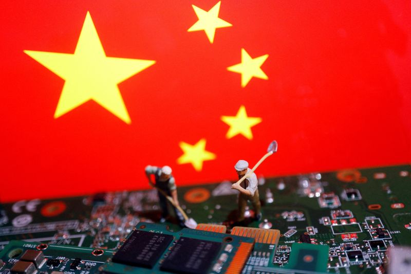 &copy; Reuters. FILE PHOTO: Worker miniatures are placed among the flag of China and printed circuit boards with semiconductor chips, in this illustration picture taken July 5, 2023. REUTERS/Florence Lo/File Photo