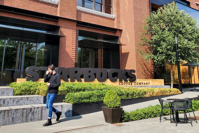 &copy; Reuters. FILE PHOTO: A person walks outside Starbucks headquarters in Seattle, Washington, U.S. September 12, 2022. REUTERS/Hilary Russ/File Photo