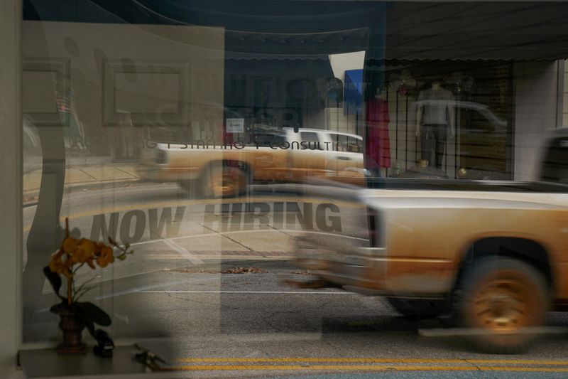 &copy; Reuters. FILE PHOTO: A "Now Hiring" sign is reflected through the window of Intuition Career staffing agency in Greenville, Alabama, U.S., December 4, 2022.  REUTERS/Cheney Orr/File Photo