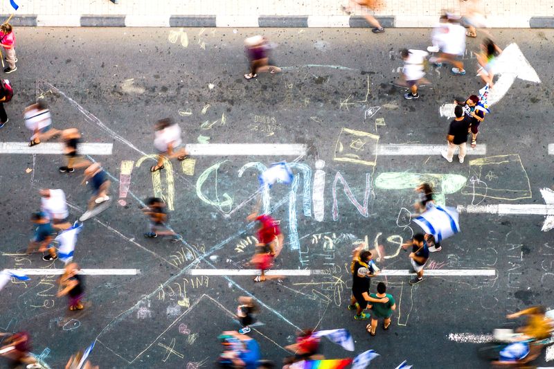 © Reuters. An aerial view shows protesters on a road that has been written on in Hebrew with the word 