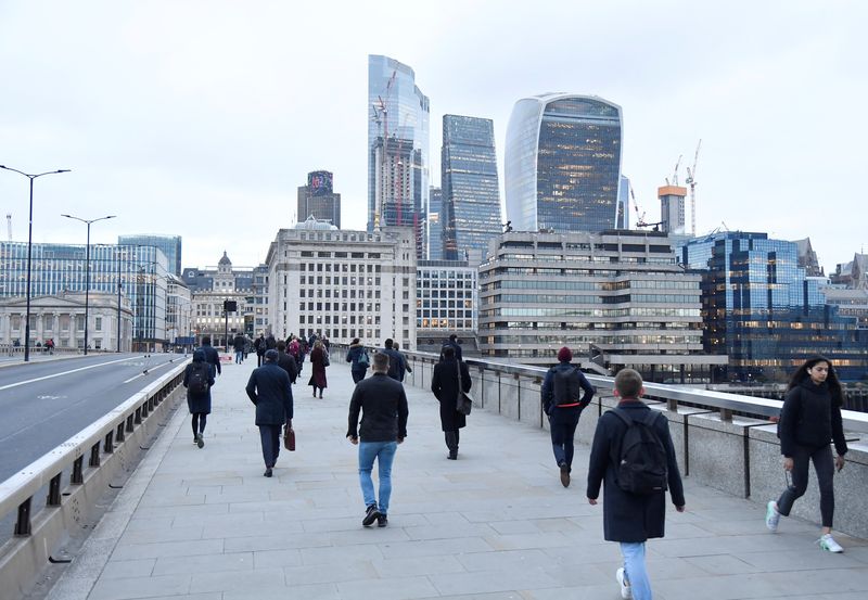 &copy; Reuters. FILE PHOTO: Workers cross London Bridge, with the City of London financial district seen behind, during the morning rush-hour, as the coronavirus disease (COVID-19) lockdown guidelines imposed by British government encourage working from home, in London, 