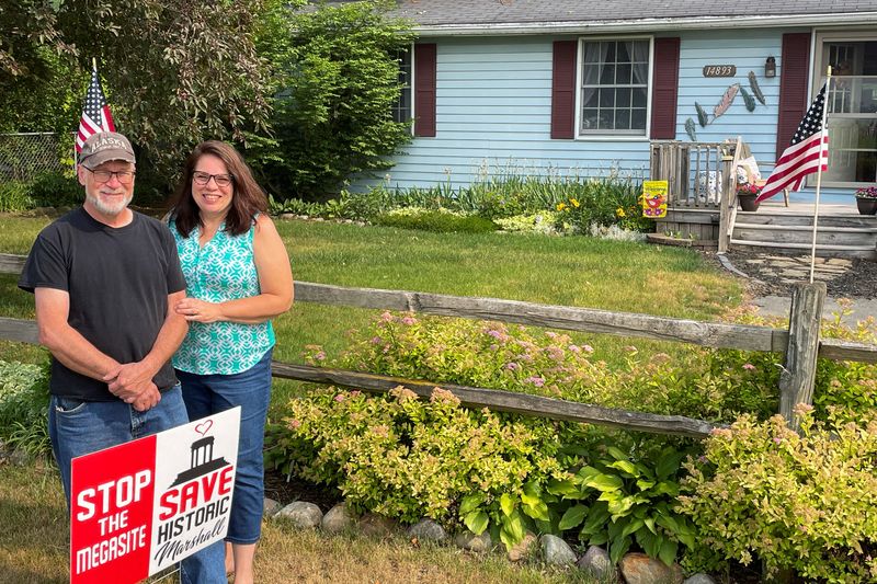 &copy; Reuters. FILE PHOTO: Fred and Joan Chapman pose for a picture in front of their house near a land that will be home to a proposed Ford Motor Co electric vehicle battery plant in Marshall Township, Michigan, U.S., June 28, 2023. They have rejected several offers fo