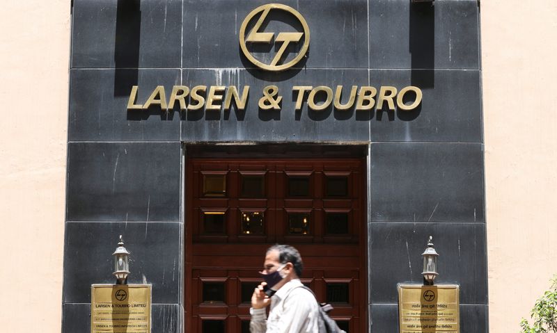 &copy; Reuters. FILE PHOTO-A man walks past the Larsen and Toubro (L&T) head office in Mumbai, India, September 2, 2021. REUTERS/Francis Mascarenhas/file photo