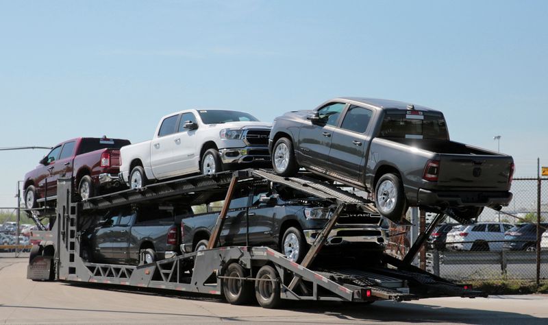 © Reuters. FILE PHOTO: A car hauler in 2018 transports Dodge Ram pick-up trucks to a holding lot across from the FCA Jefferson North Assembly Plant in Detroit, Michigan, U.S. May 25, 2018.  REUTERS/Rebecca Cook/File Photo