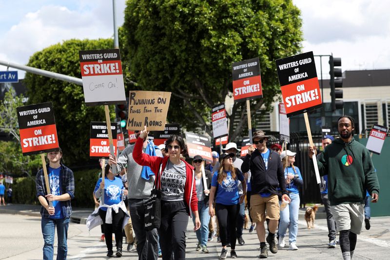 &copy; Reuters. FILE PHOTO: Workers and supporters of the Writers Guild of America protest outside Universal Studios Hollywood after union negotiators called a strike for film and television writers, in the Universal City area of Los Angeles, California, U.S., May 3, 202