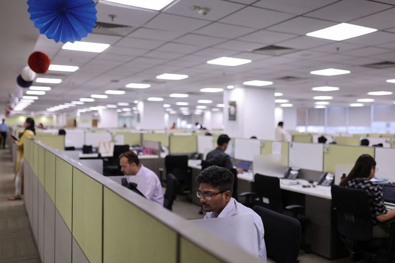 &copy; Reuters. A man works in a cubicle at Deloitte's office in Gurugram, India, June 13, 2023. REUTERS/Anushree Fadnavis