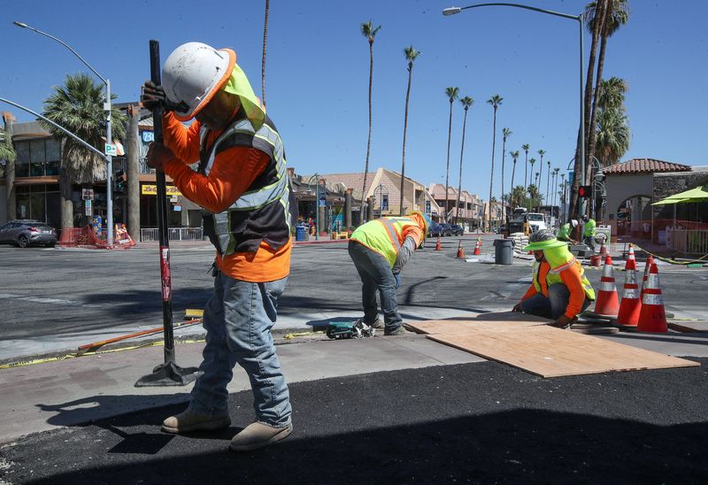 &copy; Reuters. Carlos Sandoval and other construction workers work in temperatures that were over 100 degrees F (37 degrees C) as they install new sidewalk infrastructure in downtown Palm Springs, California, U.S. July 11, 2022.  Jay Calderon/USA Today Network via REUTE