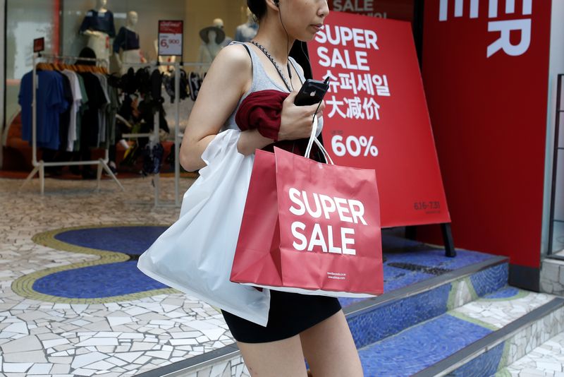 &copy; Reuters. FILE PHOTO: A woman walks out of a clothing shop in the Gangnam area of Seoul, South Korea, June 28, 2016. Picture taken June 28, 2016. REUTERS/Kim Hong-Ji/File Photo