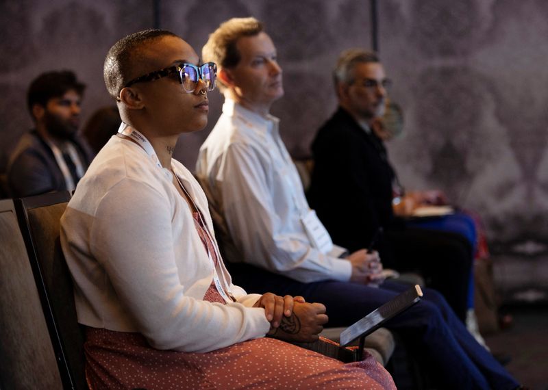 &copy; Reuters. Michelai Graham, web 3 and tech reporter for Boardroom, from left, Richard Sonnenblick, chief data scientist for Plainview, and Seth Dobrin, CEO of Trustwise, listen to speakers during the Reuters MOMENTUM event, held to discuss the development and use of